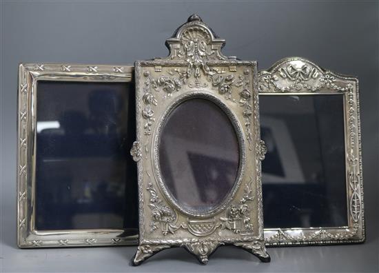 An ornate modern Brittania standard silver mounted photograph frame, Mappin & Webb, London 1987 and two other silver frames.